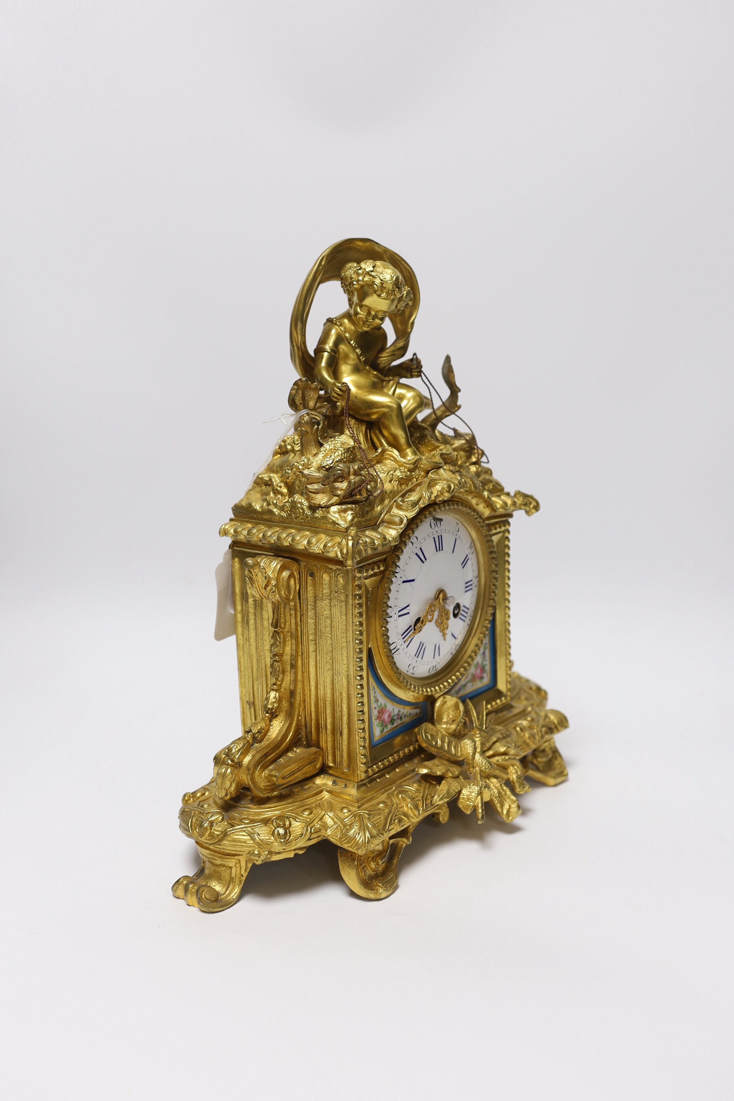 An early 20th century French ormolu mantel clock, with enamel dial, key and pendulum, 31cm